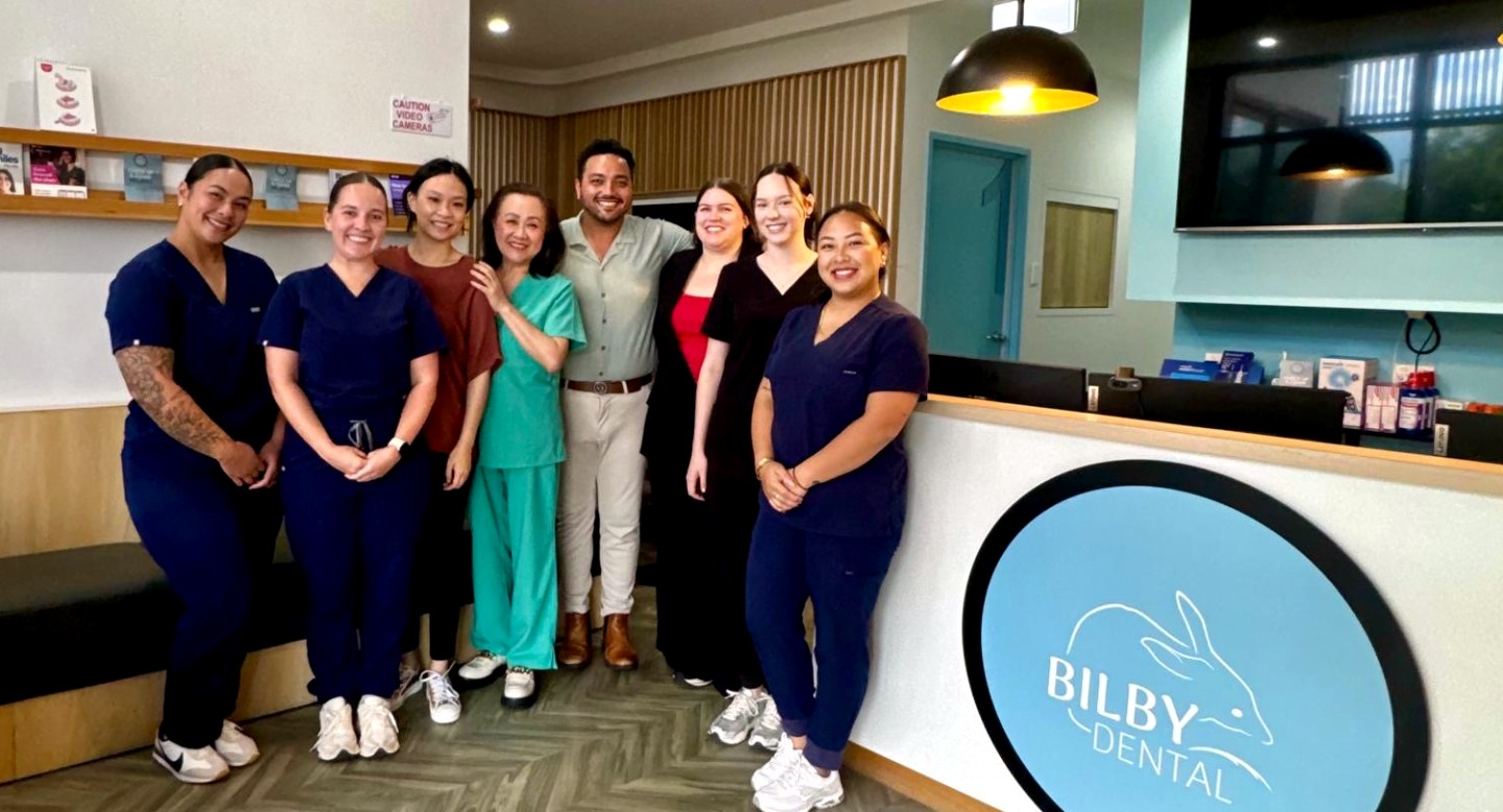 The Bilby Dental team of dentists and dental assistants at the practice reception in Yarrabilba